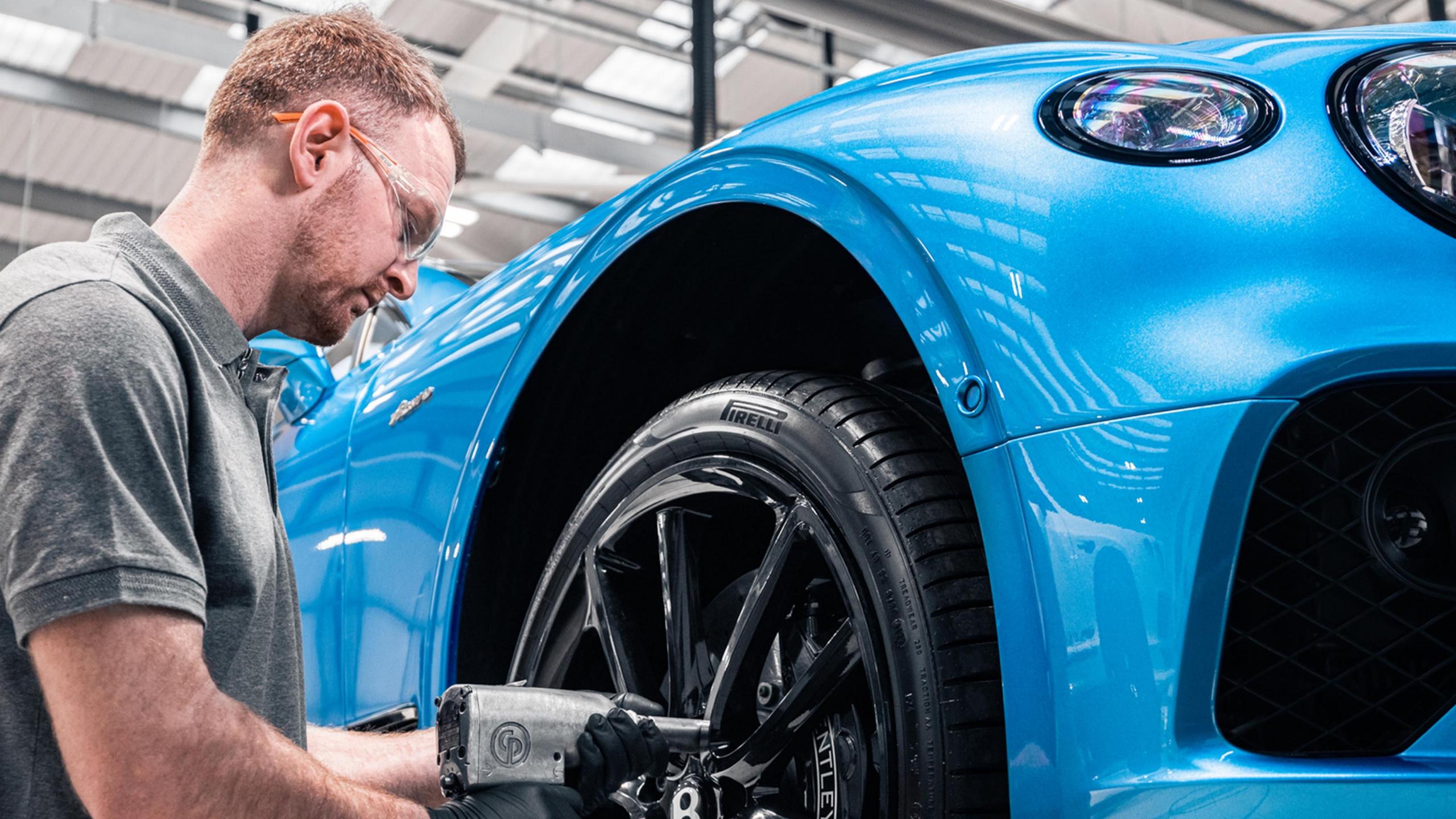 A Bentley-trained technician working on a Continental GT.